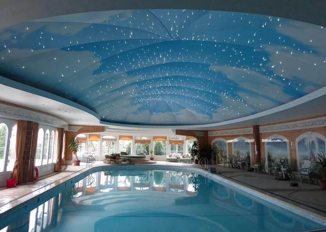 Indoor pool recessed lightbox star design above pool.