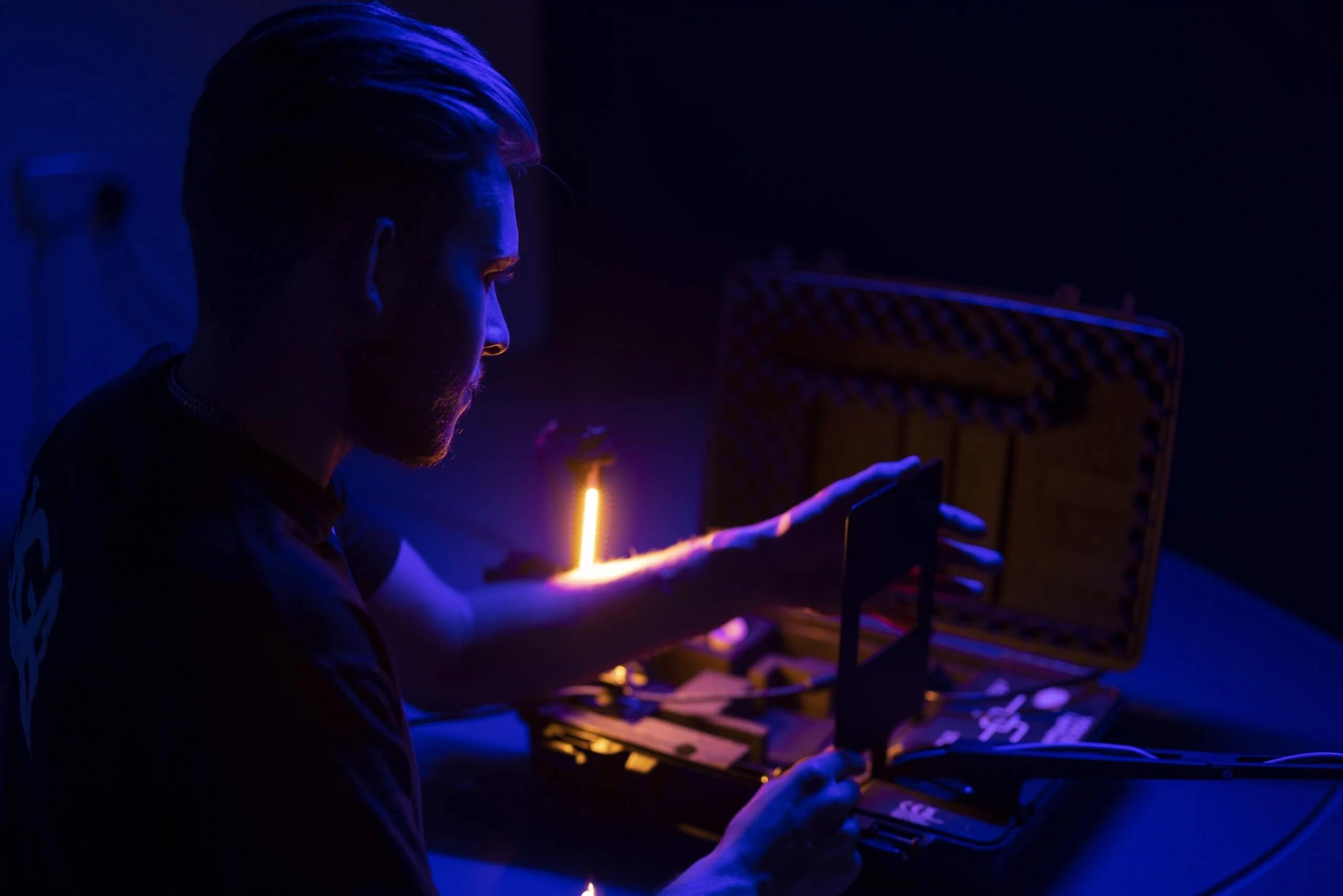 Image of Jason Alden surrounded by blue LED light reflection.