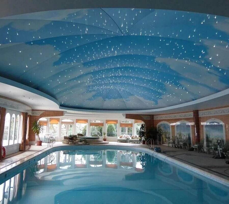 Indoor pool recessed lightbox star design above pool.