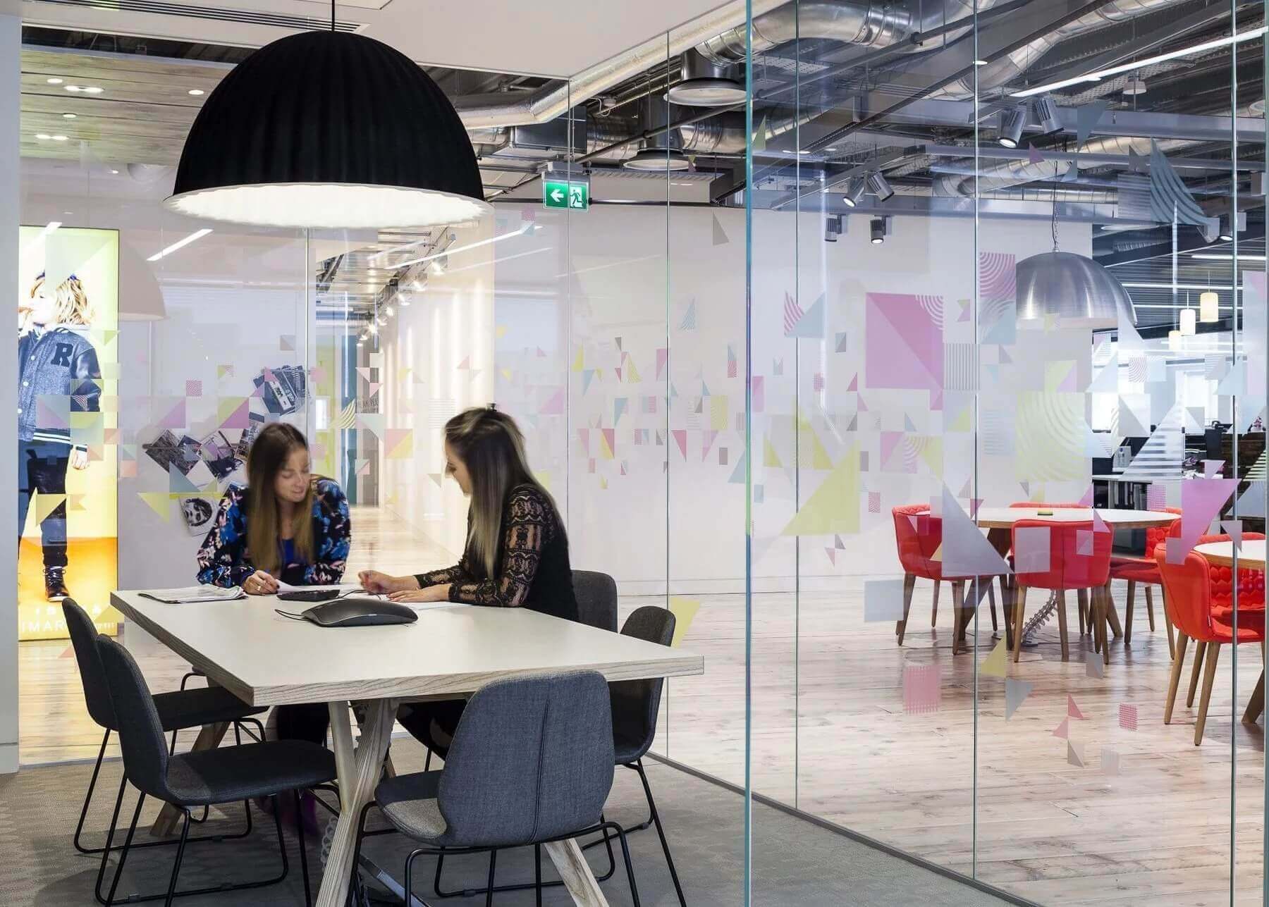 2 colleagues working in LED lit office space