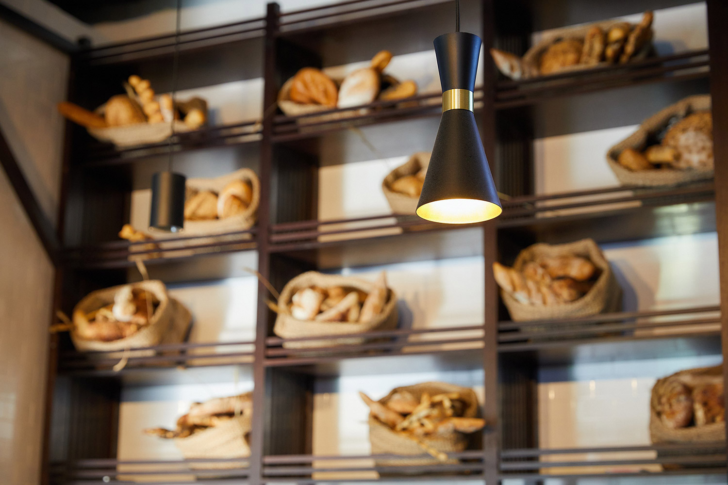 Background of a shelf with bread in baskets, focused on a hanging light