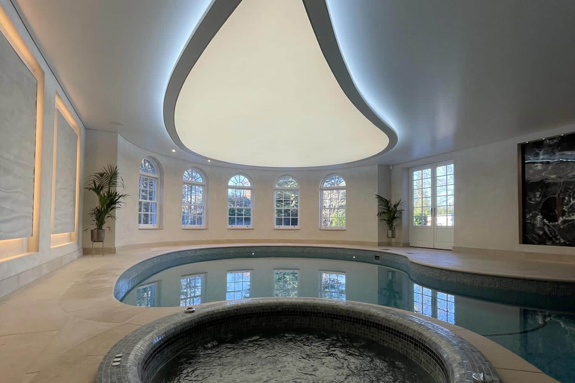 Indoor swimming pool with a Kenston teardrop ceiling light.
