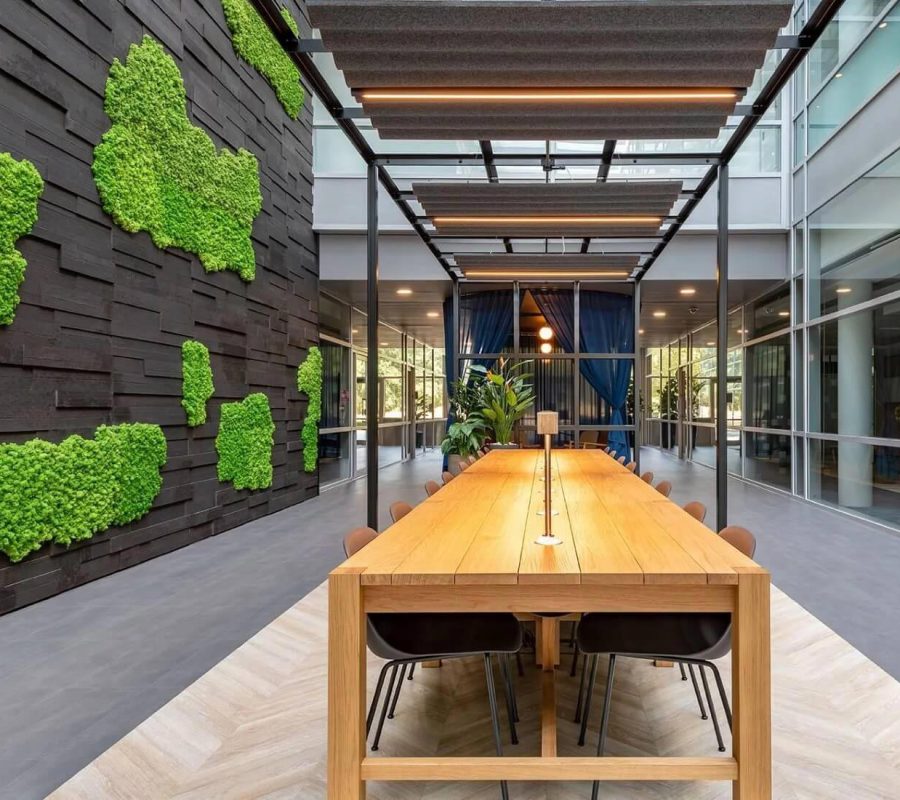 timber table and wall with green textured fabric on the walls